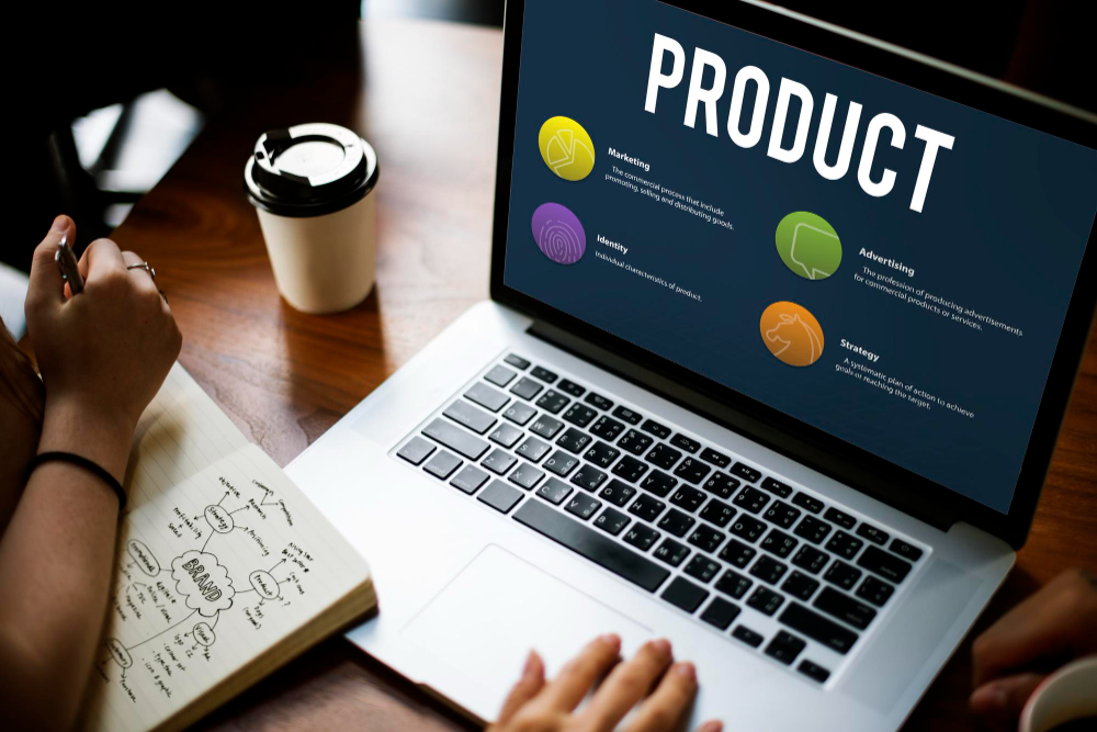 A person working on product strategy with a laptop displaying key elements of strategy